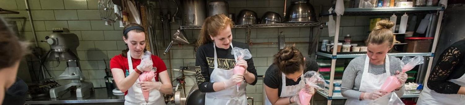 students preparing to ice cakes